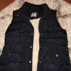 Navy w/brown accent puffer vest. Size Medium